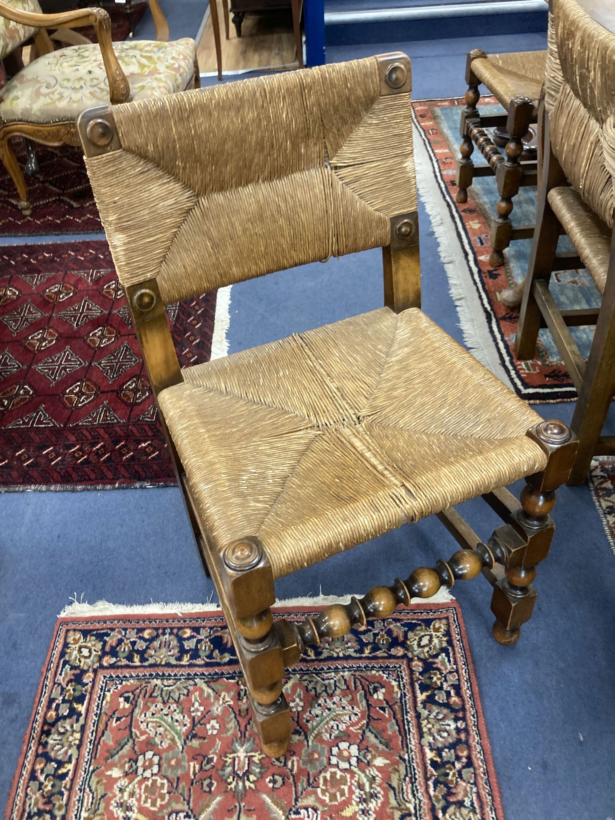 A set of eight turned beech dining chairs with rush seats and backs (two with arms)